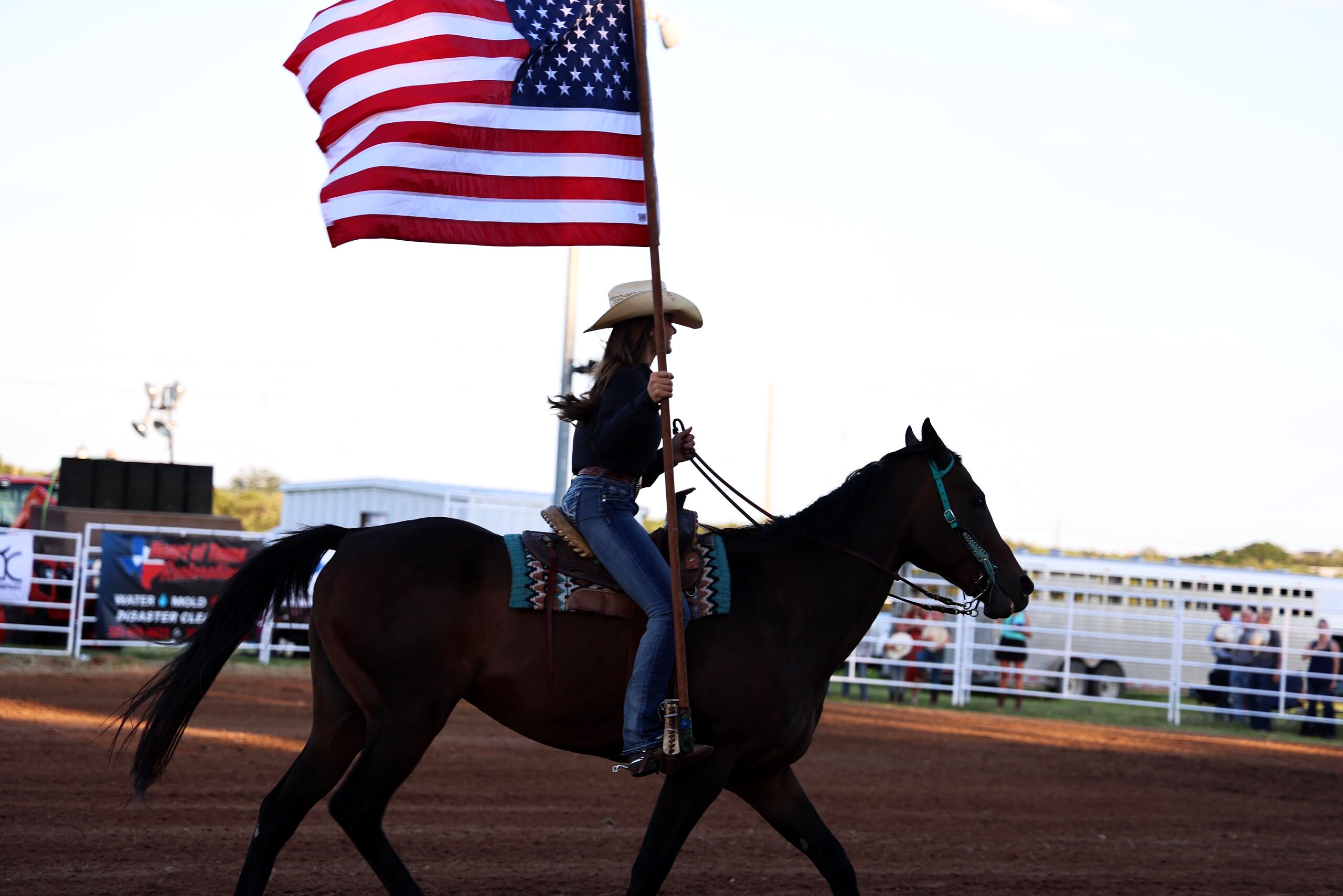 American flag carried on horseback during the arena opening