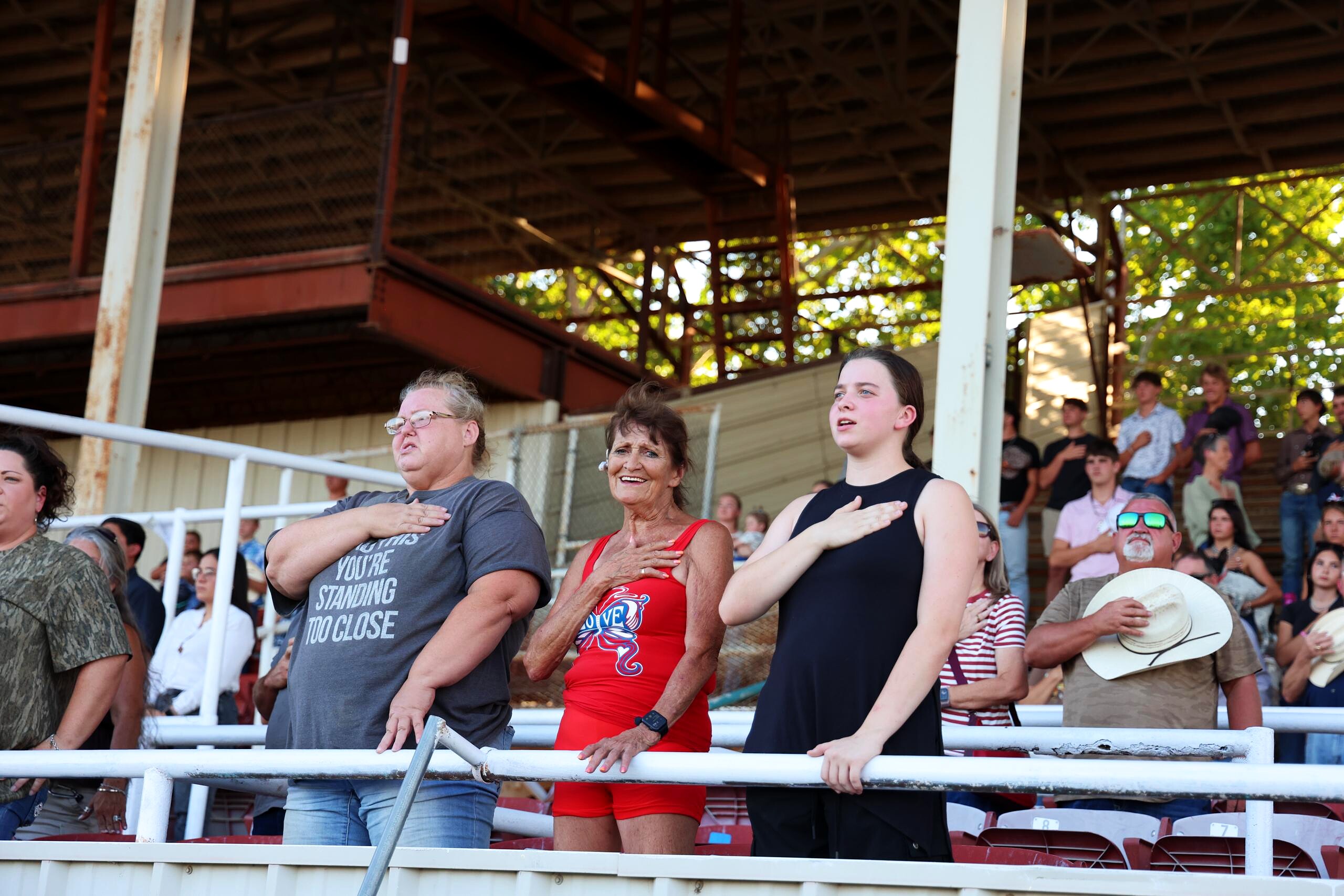 Spectators standing in the grandstand during the rodeo